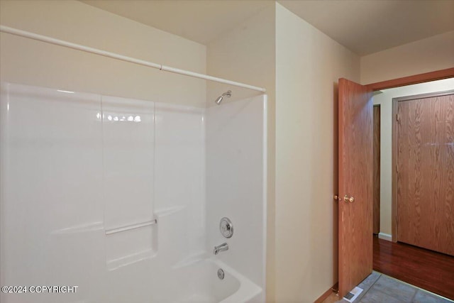 bathroom featuring hardwood / wood-style floors and shower / bath combination