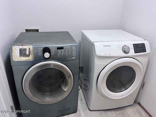 4570 S Navigators Cir, Wasilla, AK 99623 - laundry area with independent washer and dryer and light wood-style floors