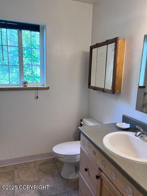 4570 S Navigators Cir, Wasilla, AK 99623 - half bathroom with vanity, toilet, and baseboards