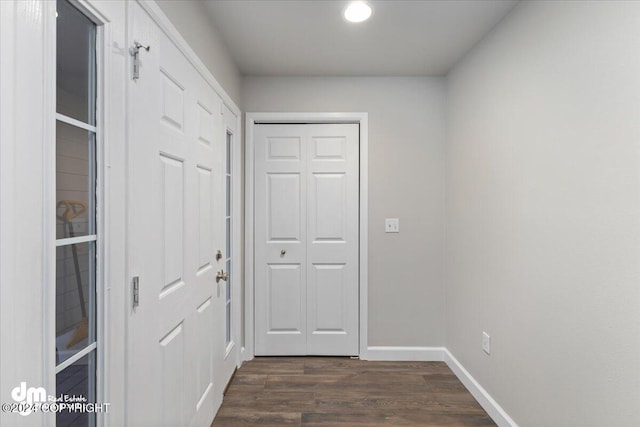 hallway with dark hardwood / wood-style floors