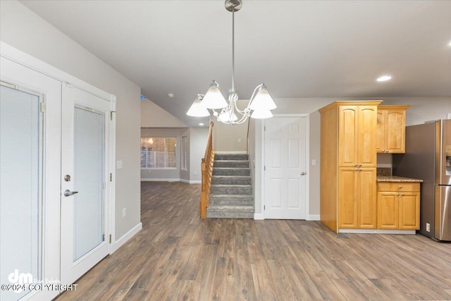 kitchen featuring hanging light fixtures, stainless steel refrigerator with ice dispenser, dark hardwood / wood-style floors, and an inviting chandelier