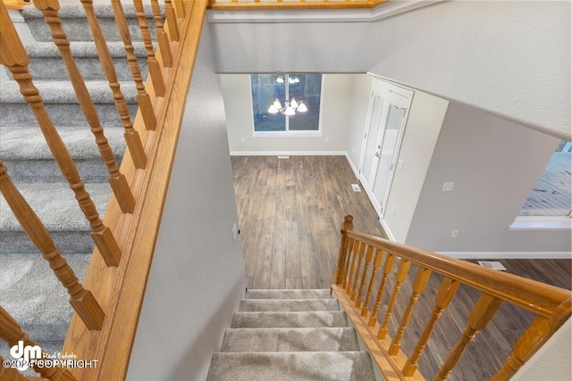 staircase with hardwood / wood-style floors