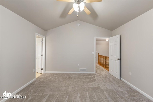 unfurnished bedroom featuring ceiling fan, light colored carpet, and lofted ceiling