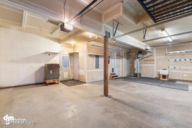 garage featuring a garage door opener, gas water heater, and electric panel