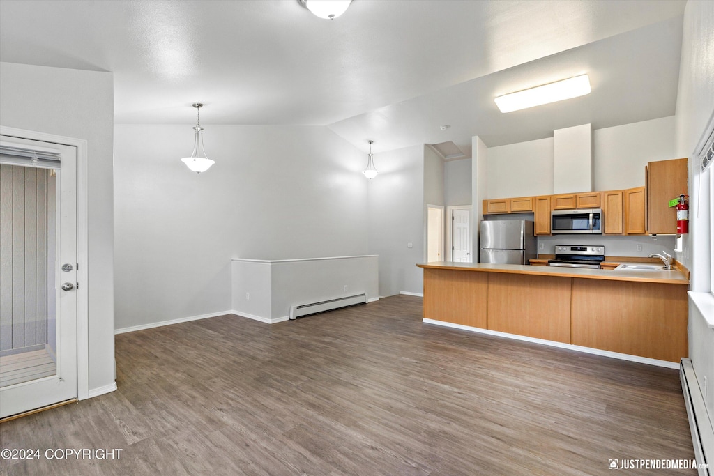 kitchen featuring lofted ceiling, dark hardwood / wood-style floors, appliances with stainless steel finishes, a baseboard radiator, and kitchen peninsula