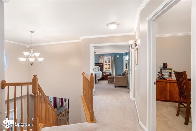 hall with ornamental molding, light carpet, and a notable chandelier