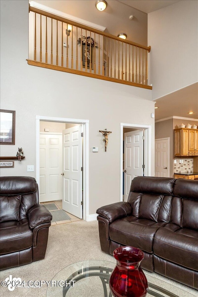 living room with light carpet and a towering ceiling