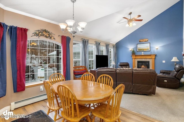 dining area featuring lofted ceiling, a baseboard radiator, ornamental molding, and light hardwood / wood-style floors