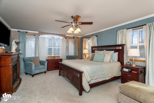 bedroom featuring ceiling fan, light colored carpet, and ornamental molding