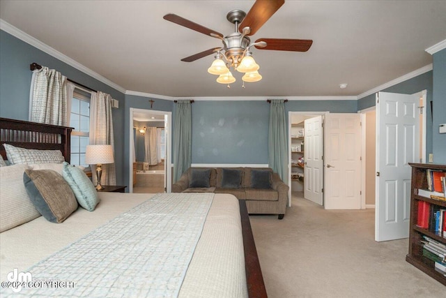 carpeted bedroom with connected bathroom, crown molding, a walk in closet, and ceiling fan