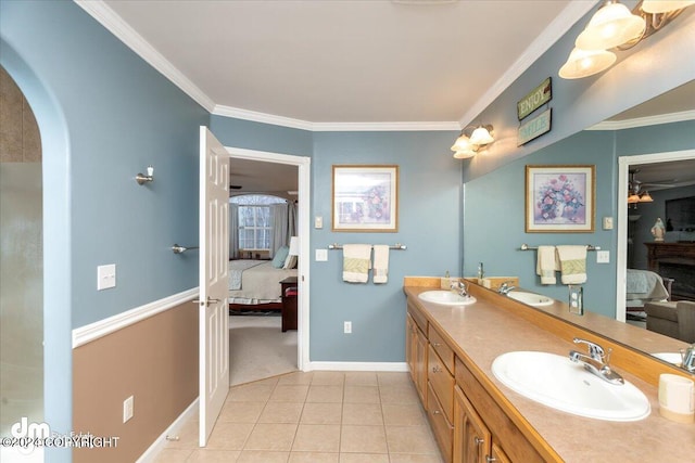 bathroom featuring tile patterned flooring, crown molding, vanity, and ceiling fan