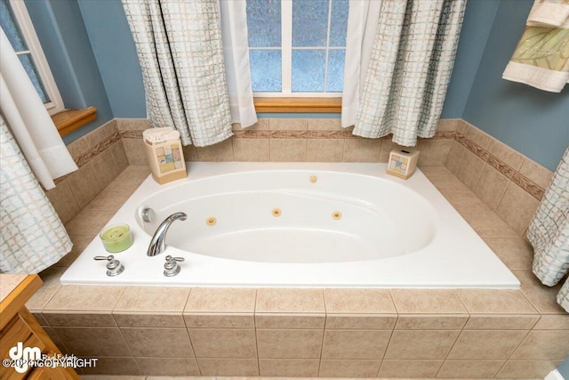 bathroom featuring tiled tub