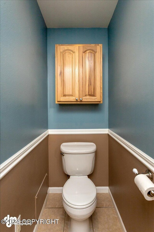 bathroom featuring tile patterned flooring and toilet