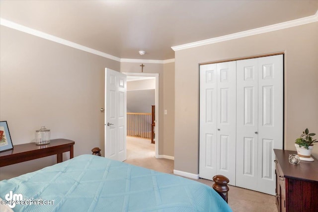 carpeted bedroom featuring ornamental molding and a closet