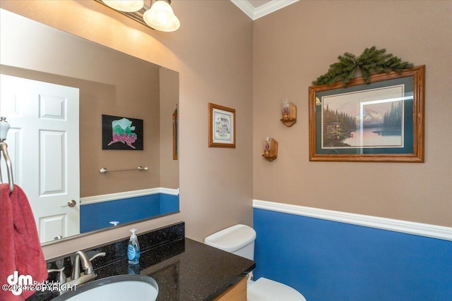 bathroom featuring vanity, crown molding, and toilet