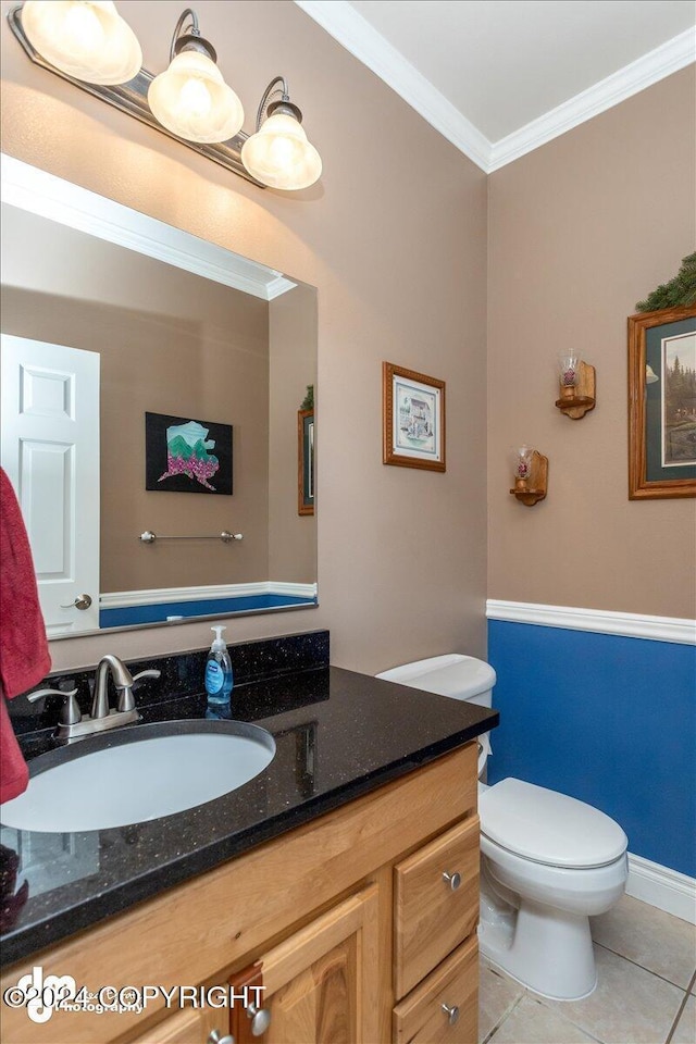 bathroom with crown molding, vanity, tile patterned floors, and toilet