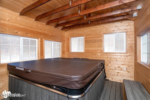 playroom with wooden ceiling, beam ceiling, and wood walls