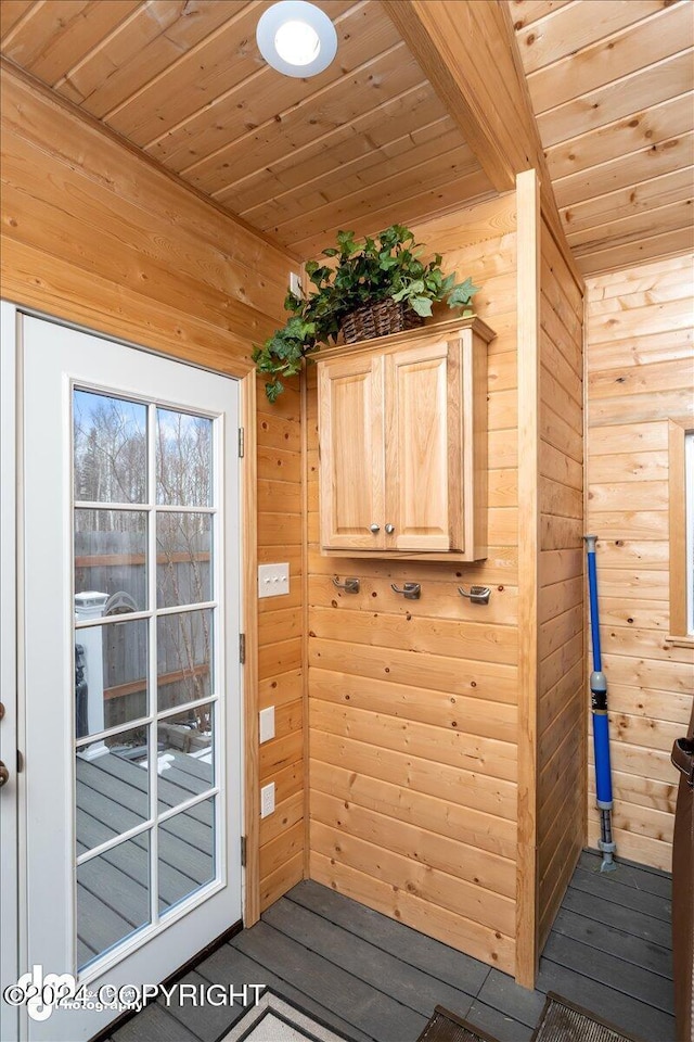 doorway with wooden walls and wooden ceiling