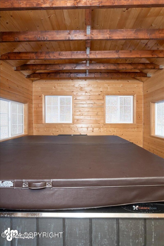 recreation room featuring beam ceiling, wood ceiling, and wooden walls