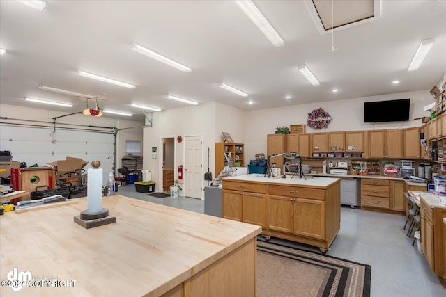 garage featuring a garage door opener and a workshop area