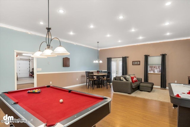 recreation room featuring crown molding and hardwood / wood-style flooring