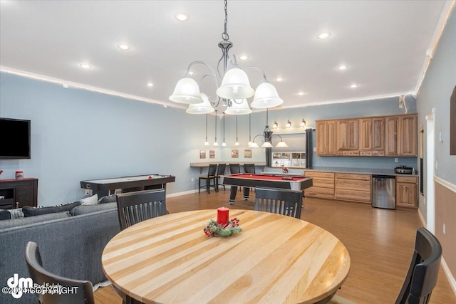 dining space featuring crown molding, pool table, and light hardwood / wood-style floors