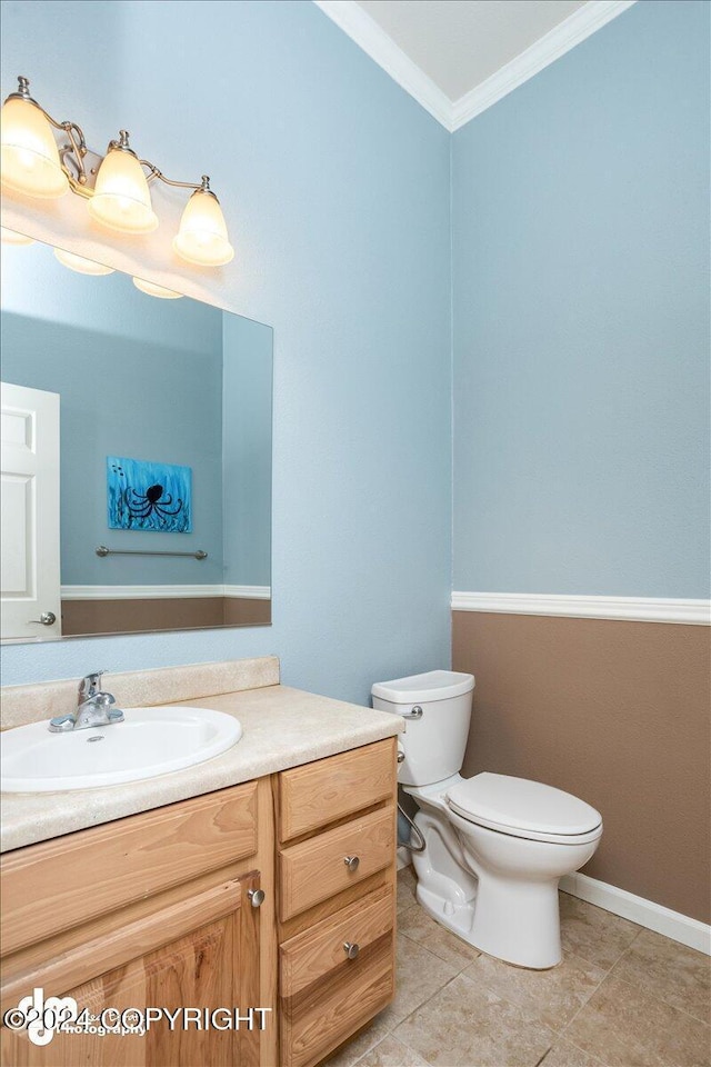 bathroom featuring vanity, tile patterned flooring, crown molding, and toilet