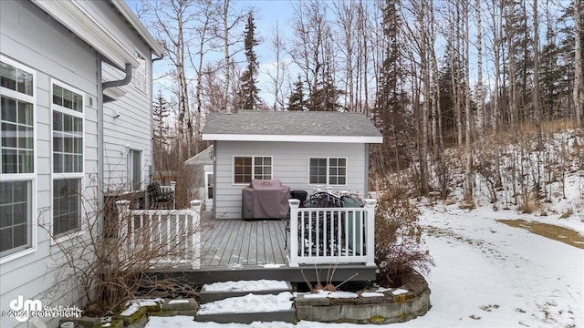 snow covered deck with a grill