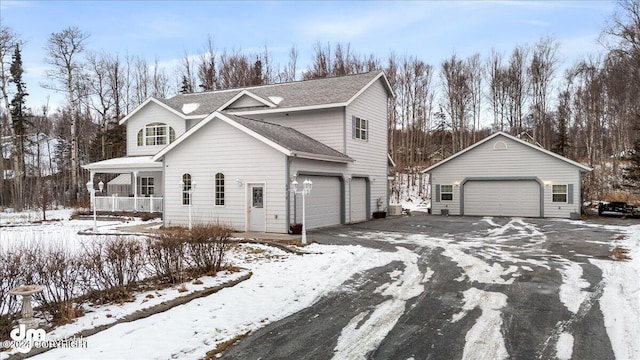 view of property with a porch and a garage