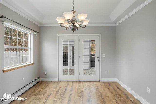 unfurnished dining area with ornamental molding, a notable chandelier, light wood finished floors, and a baseboard heating unit