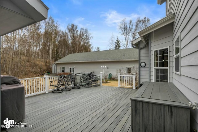 wooden terrace featuring outdoor dining area