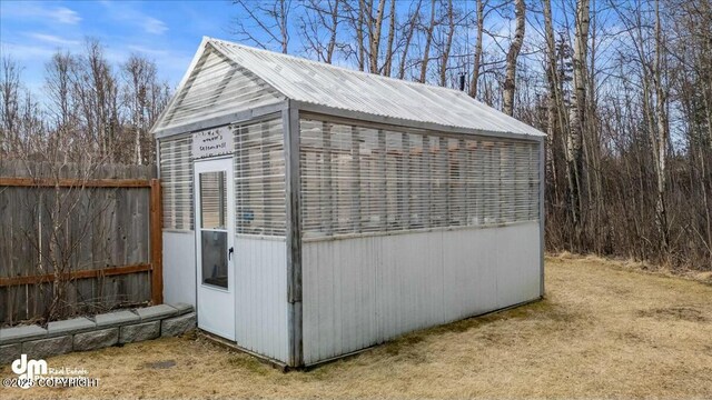 view of outbuilding with an outdoor structure and fence