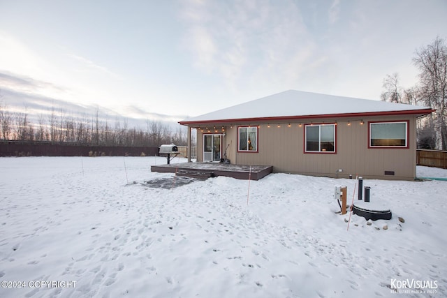 view of snow covered rear of property