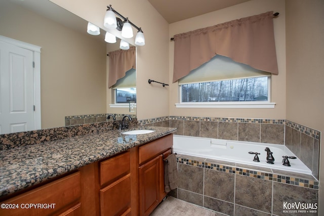 bathroom featuring vanity and a relaxing tiled tub