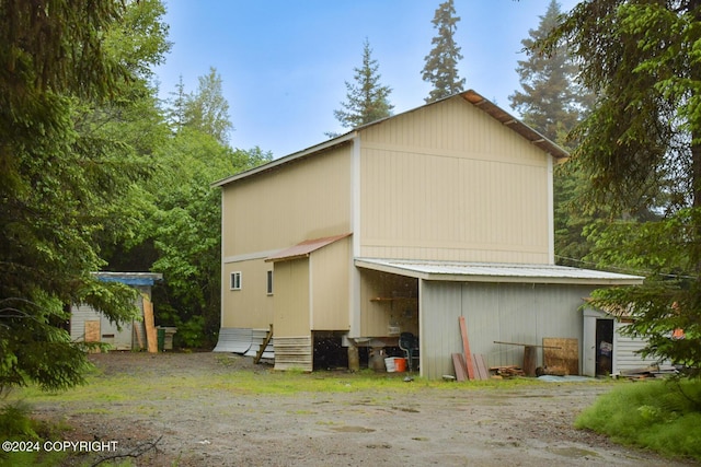 back of house with an outbuilding