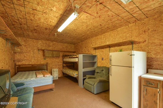 bedroom featuring white refrigerator and light colored carpet