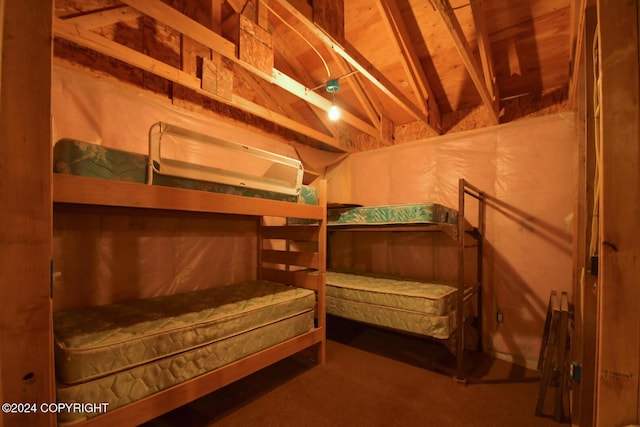 carpeted bedroom featuring lofted ceiling