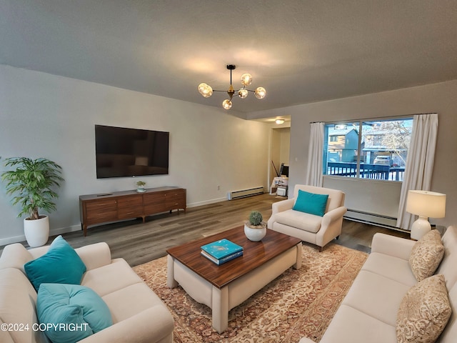 living room featuring hardwood / wood-style floors, baseboard heating, and a notable chandelier