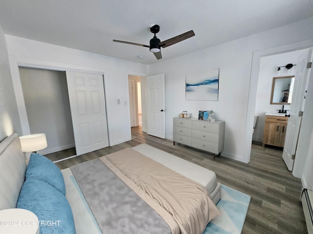 bedroom with connected bathroom, ceiling fan, dark hardwood / wood-style floors, and a baseboard heating unit