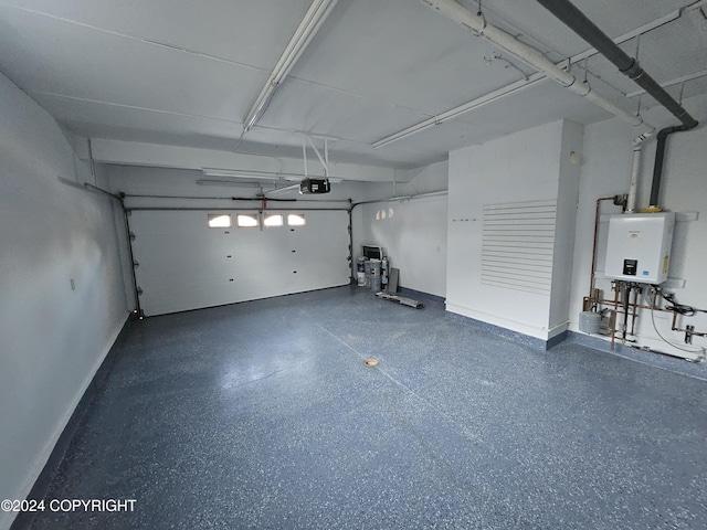 garage featuring water heater and a garage door opener