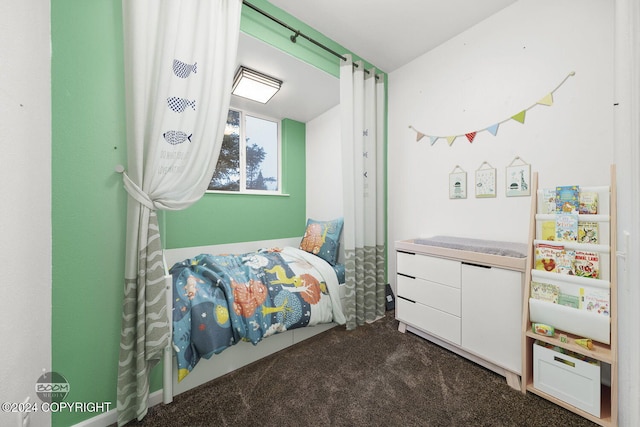 bedroom with dark colored carpet