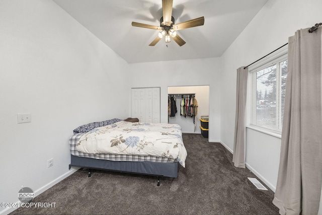 carpeted bedroom with a closet, vaulted ceiling, and ceiling fan