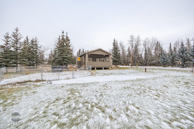 view of snow covered rear of property