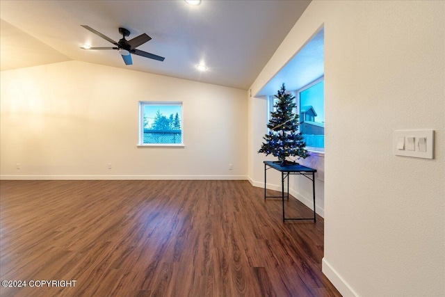 empty room featuring lofted ceiling, ceiling fan, and dark hardwood / wood-style floors