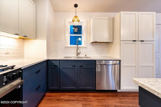 kitchen featuring pendant lighting, sink, appliances with stainless steel finishes, dark hardwood / wood-style flooring, and white cabinetry