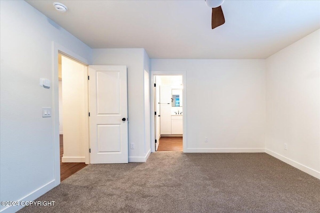 empty room featuring ceiling fan and carpet floors