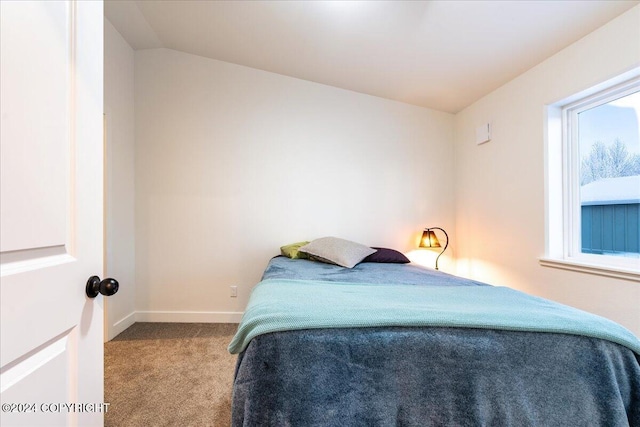 bedroom featuring light carpet and lofted ceiling