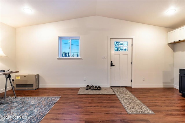 foyer featuring dark hardwood / wood-style floors and vaulted ceiling