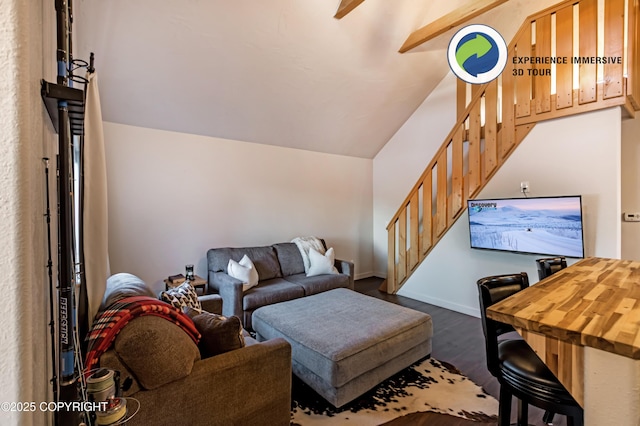 living room featuring vaulted ceiling with beams and dark hardwood / wood-style flooring