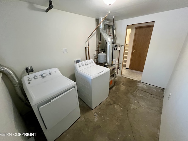 laundry area featuring gas water heater and washer and clothes dryer